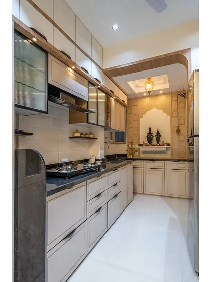 This view shows the full kitchen layout, including the integrated puja nook, demonstrating how we can incorporate spiritual spaces within the functional heart of the home.