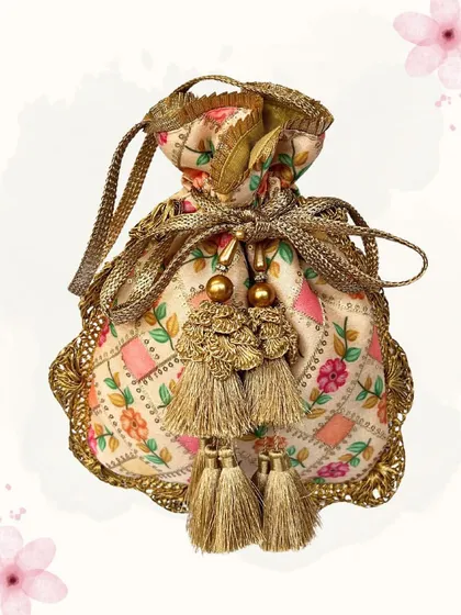 This exquisite potli bag features delicate floral embroidery and a beautiful metal-work border. The ornate tassels add a touch of luxury, making it a perfect accessory for a bride.