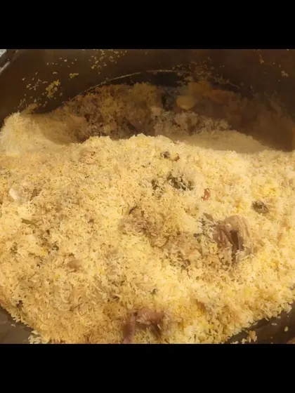 Another look inside the pot, showing the perfectly cooked mutton and rice.