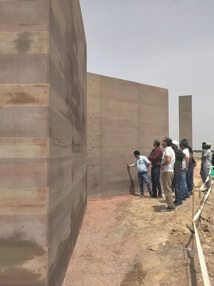 Our process is deeply hands-on and site-specific. Here, our team examines the texture and form of rammed earth walls on-site, a dialogue between material, tradition, and modern construction that allows the architecture to evolve with the land it inhabits.