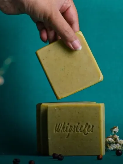 A hand holding our Green Zest soap, showcasing its clean, simple form. It's a perfect example of how we blend natural ingredients for an effective and uplifting experience.