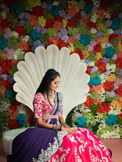 The bride is the heart of the celebration. For this aqua-themed mehendi, I designed a custom seashell throne set against a vibrant wall of flowers, creating a perfect, picturesque moment for the bride-to-be.