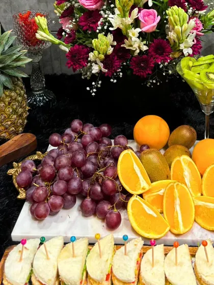 A close-up of a fresh fruit platter, part of a larger grazing table. We use vibrant, high-quality produce like grapes and oranges to add natural sweetness and color to our spreads.