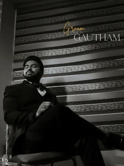 A classic black and white portrait of the groom, looking suave and confident. The dramatic lighting adds a touch of old-world charm and sophistication.