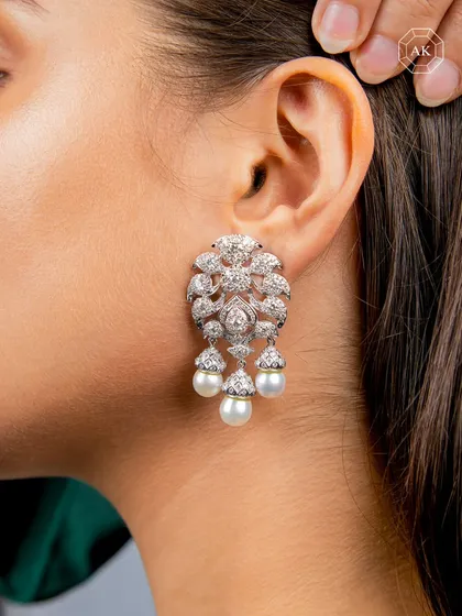 Designed for life's grand celebrations, this statement piece features three South Sea pearls set against a contemporary design fully encrusted with brilliant round diamonds.