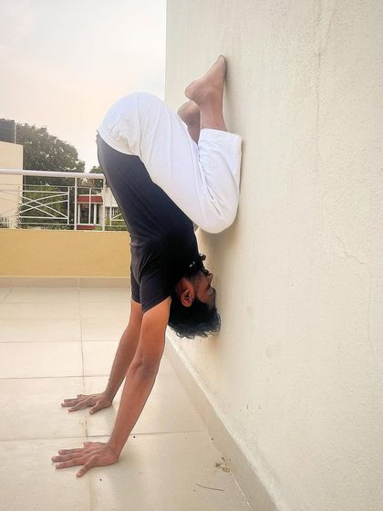 Using the wall to practice a tucked handstand. This is an excellent way to build the strength and body awareness needed for freestanding inversions.
