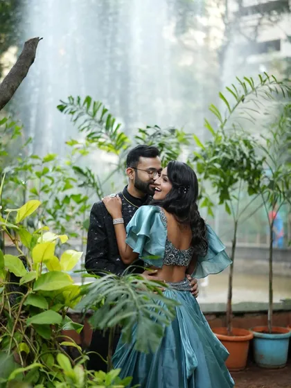 A candid, romantic moment between the couple. Her backless gown and the soft makeup create a look that is both elegant and modern.