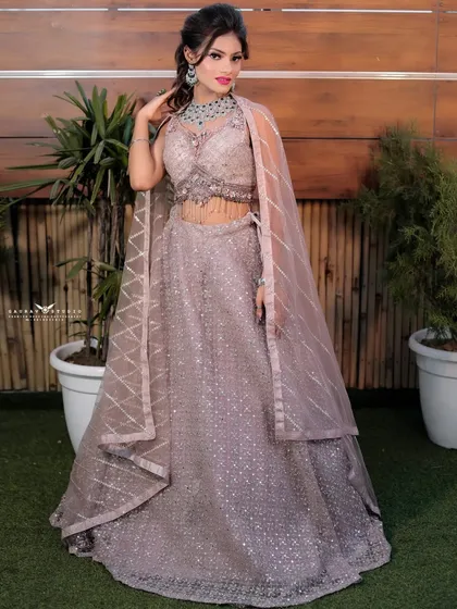 A full-length portrait of the model, showcasing the modern lehenga with a stylish cape-style dupatta.
