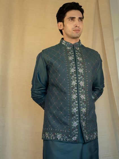 Step into elegance with our Reshmi Embroidered Teal Jacket set, uniquely crafted and customized to reflect your personal style.