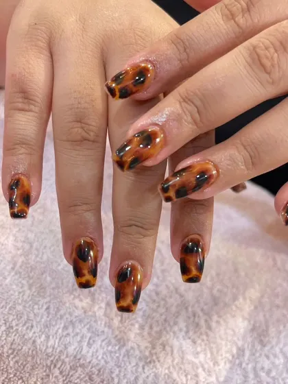 This is my take on the timeless tortoiseshell pattern. I create this classic, glossy design on coffin-shaped nail extensions, showing how a sophisticated print can elevate your everyday look.