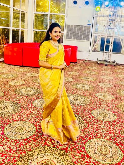 Our client Babitha looks lovely in a designer silk saree in golden and lavender hues.