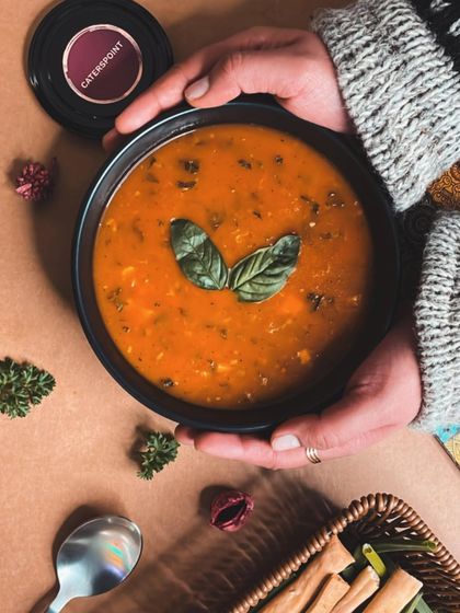 Our Killer Soup, the Basil Sun-dried Tomato Soup, is a winter favorite. This image captures the rich, comforting warmth of this delicious soup.