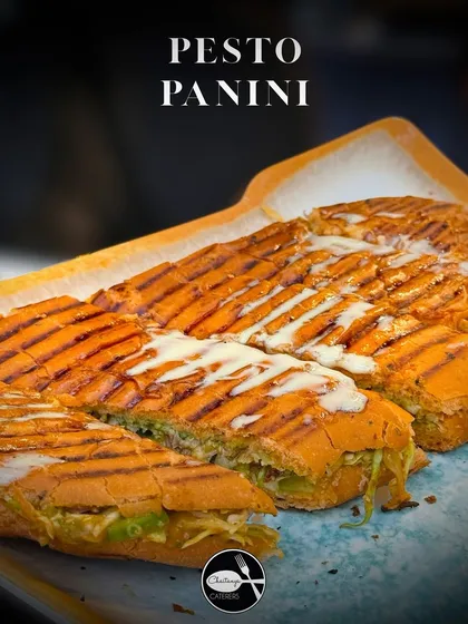 A classic Pesto Panini, perfectly grilled for a satisfying crunch. I layer crisp bread with fresh basil pesto, melted cheese, and garden vegetables, making it an ideal snack for high tea events or as a light bite.