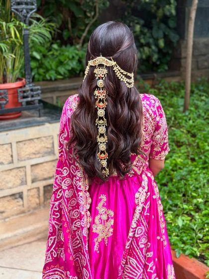 A clearer back view of the magnificent cascading hair jewellery on a bed of soft waves.