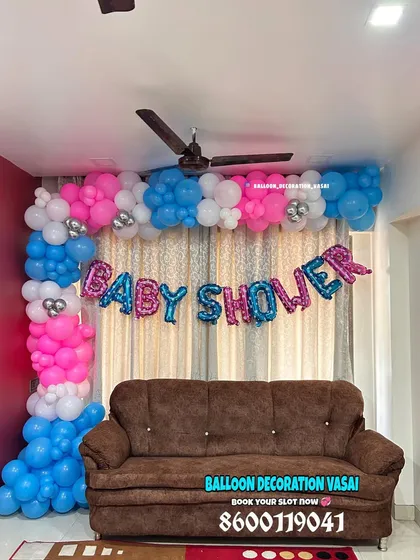 For a simple and budget-friendly option, I can create a beautiful balloon frame around a curtained wall. The "Baby Shower" foil balloons are a great way to make a statement.