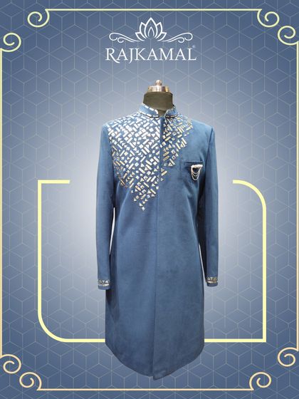 A full-length view of the blue mirror-work jacket, showcasing its modern cut and festive appeal.