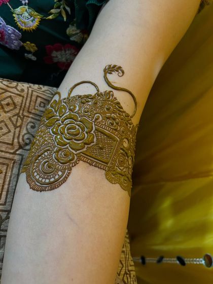 A close-up of the armband from an Indian bridal design. The details are incredibly fine, with a beautiful rose and vine motif.