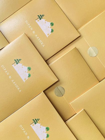 A simple yet charming invitation for a 'kankotri' writing ceremony. The minimalist illustration and clean design on a warm yellow envelope make for a lovely and modern take on a traditional event.