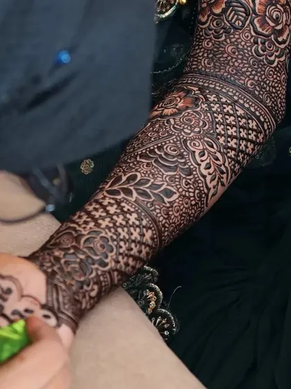 Another angle of me adding the personalized calligraphy to the bride's arm.
