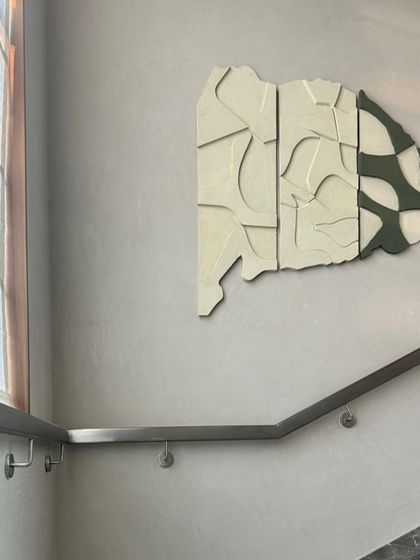 A multi-panel sculptural piece installed along a staircase in a Hyderabad home. The artwork's shape flows with the architecture, creating a custom, integrated look.