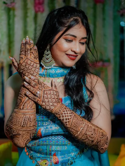 A beautiful bride admiring her intricate mehndi design. I focus on capturing these details, as they are a significant part of the bridal transformation and story.