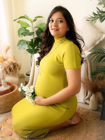 A bright and joyful portrait in my boho studio corner. The combination of natural textures, greenery, and a simple, colourful dress makes for a fresh and happy maternity photo.