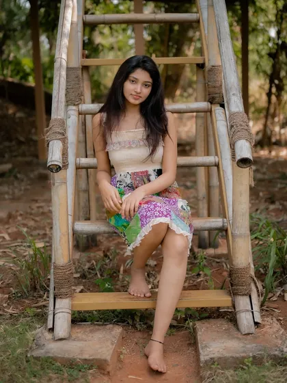 A duplicate of image 70, this candid and happy portrait of actress Rachana Inder on a bamboo ladder is full of joy and natural beauty.