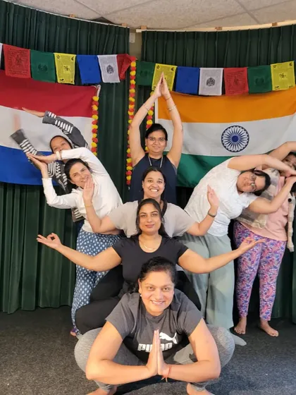 Our students creatively form a lotus flower shape with their bodies. This fun, collaborative pose showcases the teamwork and joyful spirit of our yoga community.