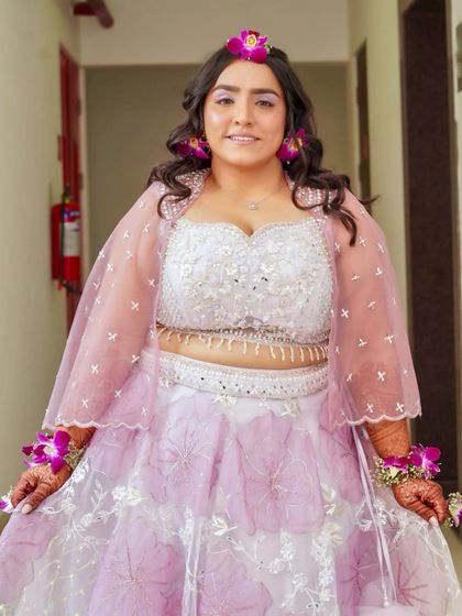 This bride is glowing and ready for her Haldi ceremony. The makeup enhances her natural radiance with a dewy finish and a soft, pretty lip color.