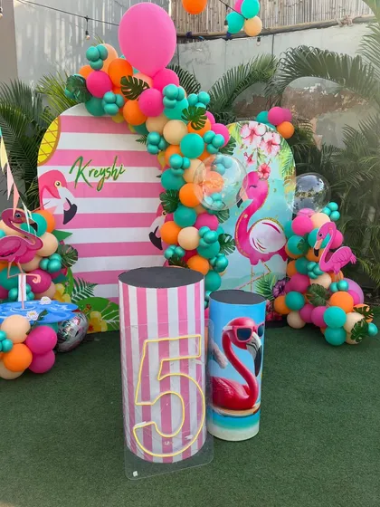 A flamingo-themed photo booth for a 5th birthday pool party. We love creating personalized and picture-perfect moments.