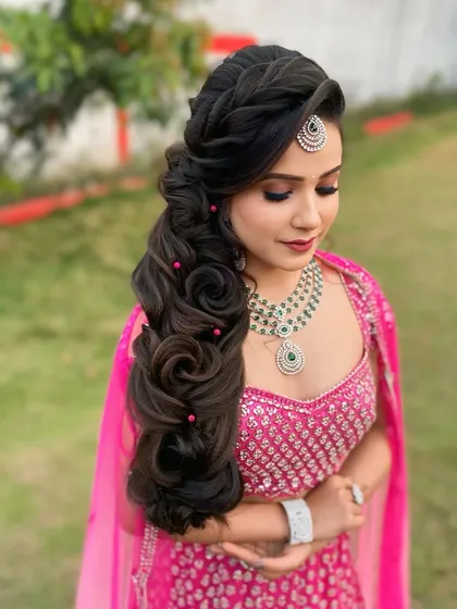 Here is a beautiful rose pattern braid for a pre wedding event. This side swept style is both romantic and modern, making it a great choice for a sangeet or engagement party.