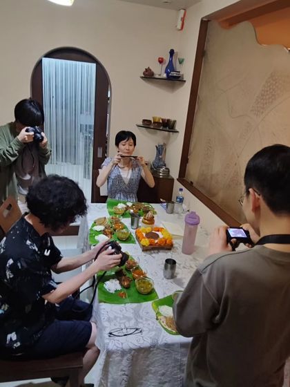 The moment before the feast begins! These travellers from Japan were so excited to capture every detail of the Maharashtrian meal before diving in. It's a joy to share my cuisine with people who appreciate it so much.