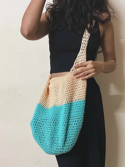 Here I am modeling one of my simple mesh-style tote bags. This two-toned design in beige and turquoise is lightweight and can stretch to hold a surprising amount.