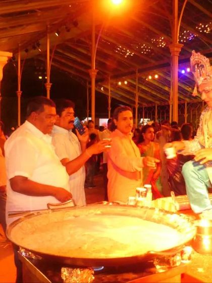 A live dessert station where a chef in costume prepares a traditional sweet. This kind of interactive food station is a highlight at many royal weddings I cater.