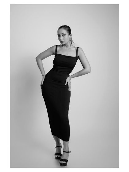 A classic full-length pose in black and white, ideal for a minimalist and chic brand lookbook.