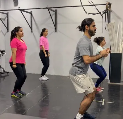 Members practicing their squat form during our weightlifting seminar. We regularly host events like this to help our community upgrade their skills and lift better, heavier, and stronger.