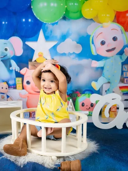 This little one is having a blast in her Cocomelon-themed setup, complete with a rainbow of balloons and all her favorite characters.