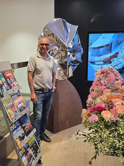 At a group show at the Audi Mumbai South showroom, standing with my sculpture "Eclipse."