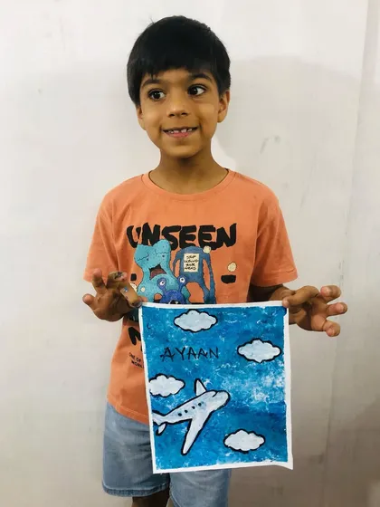 Meet Ayaan, one of our little artists from the summer art camp, proudly holding his airplane canvas painting. It's all about having fun and creating something to be proud of.