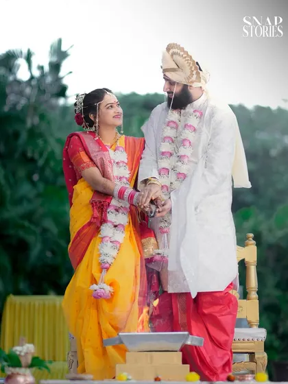 The couple holds hands during the ceremony, sharing a look of love. These are the candid, emotional moments that form the heart of your wedding story.