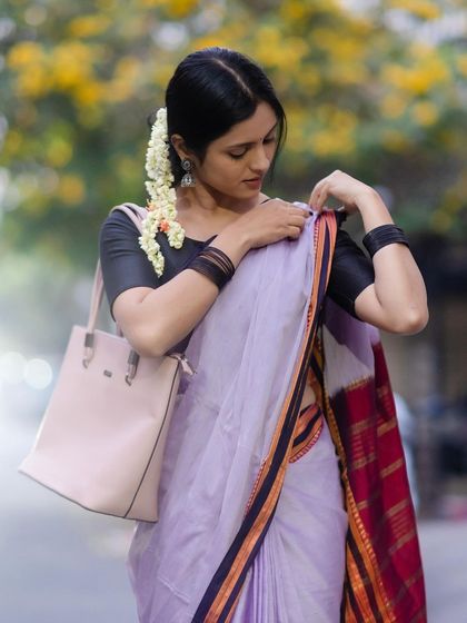 The combination of the tote bag and the traditional saree shows how easily heritage weaves can be integrated into a modern wardrobe.
