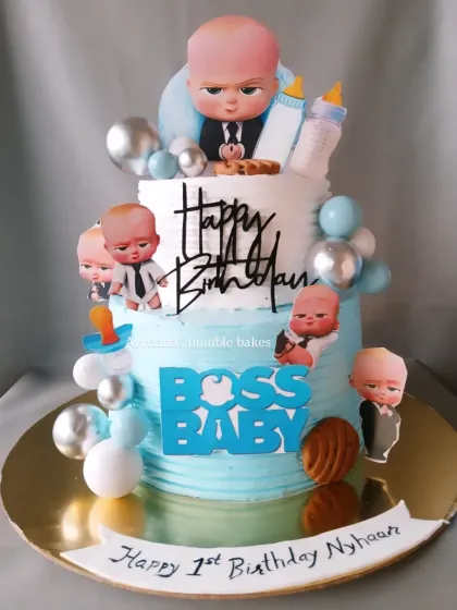 For little Nyhaan's first birthday, we created this fun two-tiered Boss Baby cake. It's one of my most requested cartoon themes, and I love bringing this character to life with lots of fun details, all completely eggless.