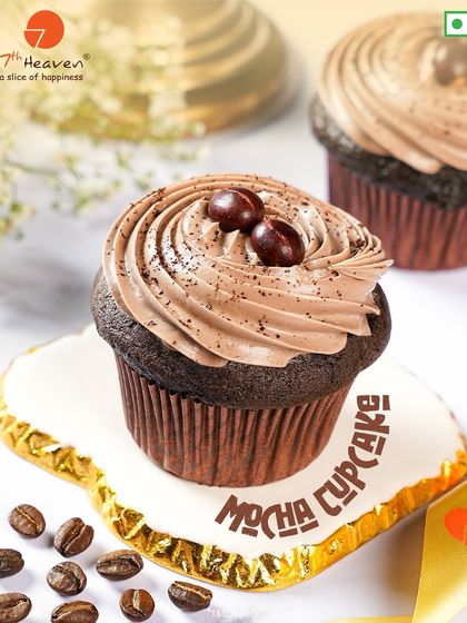 A classic Mocha Cupcake for coffee and chocolate lovers. This rich chocolate cupcake is topped with a smooth coffee-infused frosting and two chocolate coffee beans.
