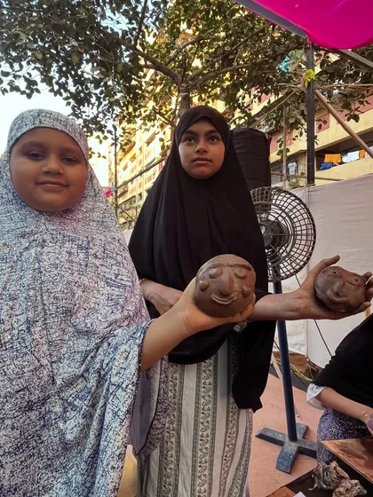 Two participants from the Govandi Arts Festival showing the expressive clay faces they made. Art has a way of connecting us all, and I am so grateful for these moments.