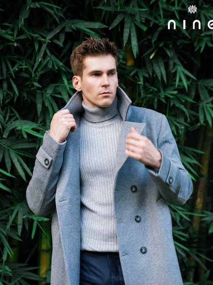 A close-up of the overcoat's collar and lapels, showcasing the sharp tailoring.