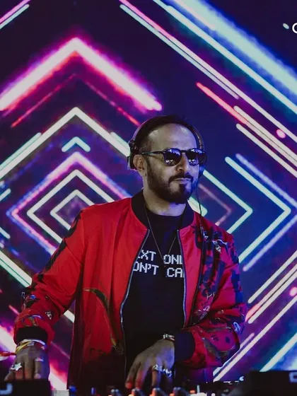 A DJ in his element against a backdrop of stunning visuals at our NYE 2025 party. We invest in high-quality LED screens and visual content to create an immersive atmosphere.