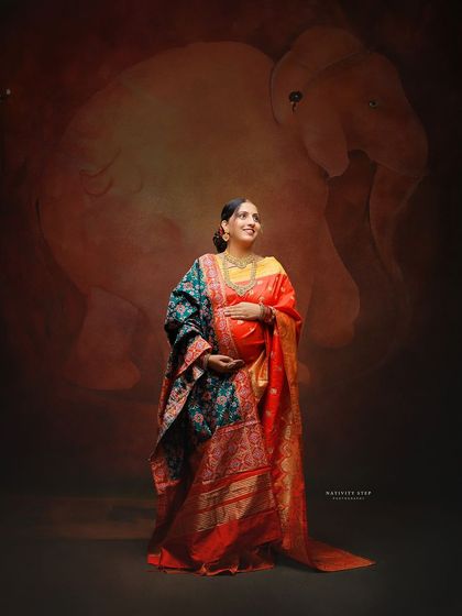 Another variation with a beautiful Patola-style dupatta, adding more texture and richness to the traditional maternity look.