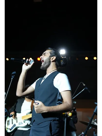 A close-up of our vocalist Aryaman, passionate and in his element during a performance for a corporate client.