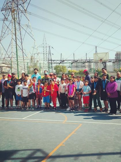 A large group photo of all the participants, coaches, and parents at an Inter-Society basketball event. It takes a community to build a strong sports culture.