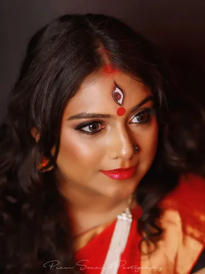 I love getting creative for themed photoshoots. For this Navratri-inspired Devi look, we focused on powerful, expressive eyes and artistic details like the hand-painted third eye, creating a truly memorable and divine portrait.
